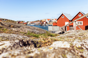 Holzhäuser in Schwedenrot am Wasser in den Schären am Ort Smögen an der schwedischen Westküste
